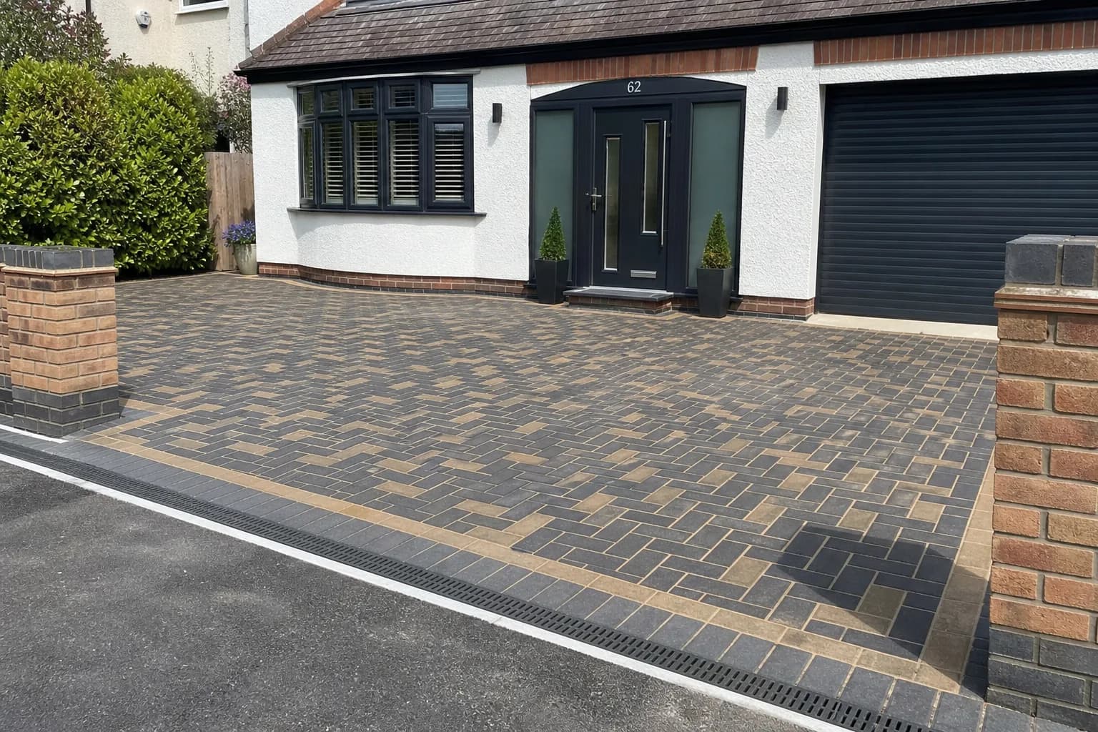 Newly laid block paving driveway with a neat herringbone pattern and edging